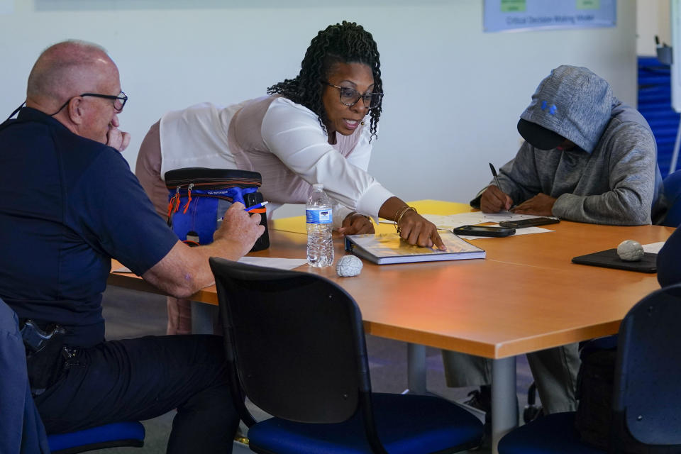 Baltimore Police Department Lt. Lakishia Tucker, center, leads a professional development class with members of the police department, Thursday, Sept. 28, 2023, in Baltimore. As law enforcement agencies across the country pursue reform measures, the Baltimore Police Department is requiring its members to complete a program on emotional regulation that teaches them the basics of brain science by examining the relationship between thoughts, feelings and actions. (AP Photo/Julio Cortez)