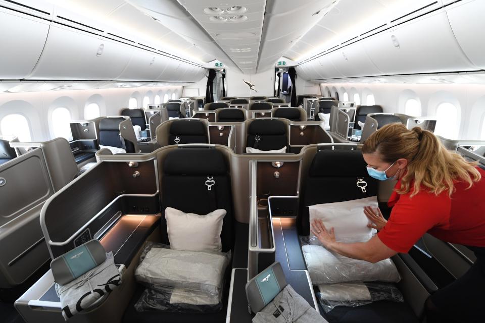 A Qantas cabin crew member checks the business class cabin on board a Boeing 787 Dreamliner aircraft.