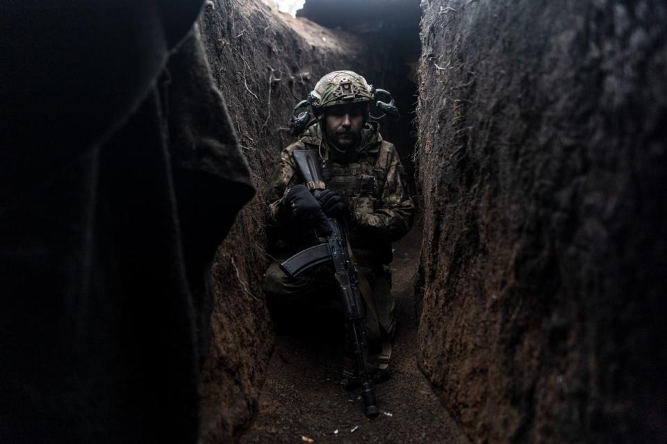 A Ukrainian soldier crouching in a trench in his infantry position as the Russia-Ukraine war continues in the direction of Kupiansk, Kharkiv Oblast, Ukraine on March 10, 2024. (PDiego Herrera Carcedo/Anadolu via Getty Images)