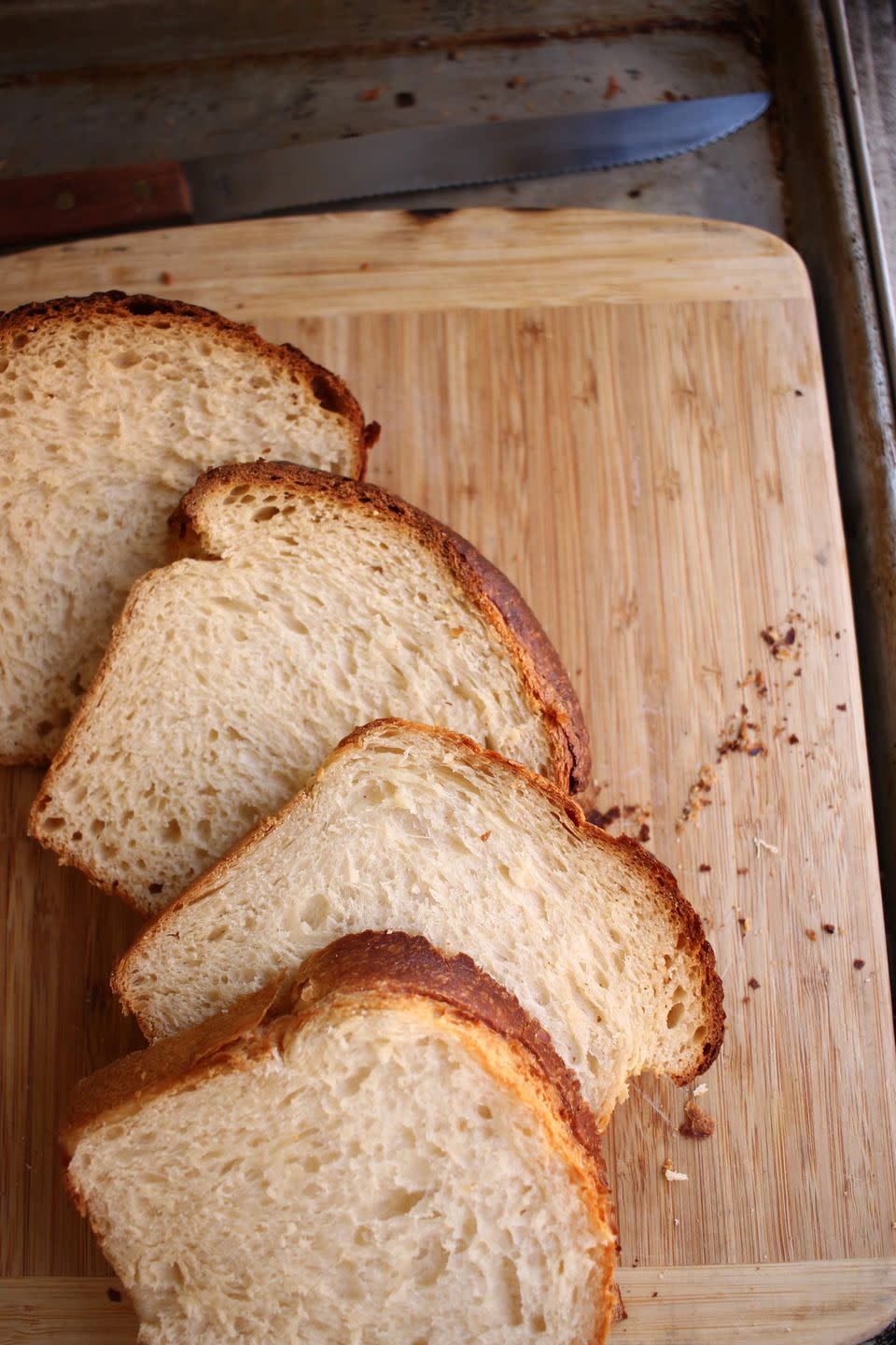 4 slices of milk bread on a wooden cutting board