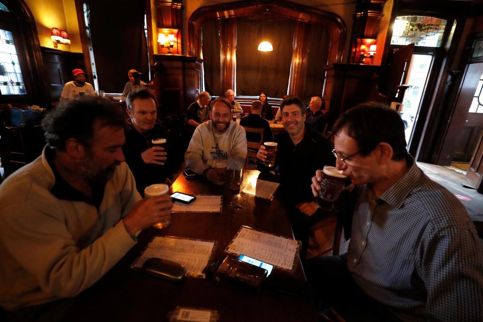 <p>People enjoying a drink at The Forester pub in Ealing on Monday evening</p> (AP)