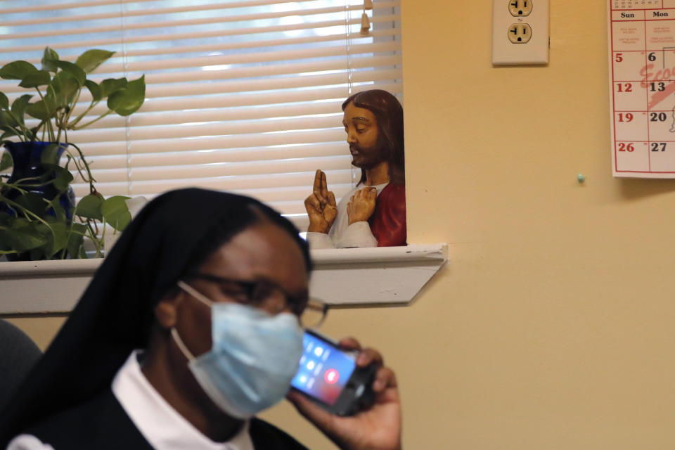 A bust of Jesus sits on a window sill as Sister Andria Donald, of the Sisters of the Holy Family, talks on a phone, at the St. John Berchmans Early Childhood Care Center, run by the sisters, in New Orleans, Thursday, July 23, 2020. “The teaching of anti-racism is pretty strong in Catholic schools,” said Kathy Mears, the NCEA's interim president. “But teaching the contributions of Black Catholics to our history is not where it should have been. Whatever we can do to correct this error, we’re all in.” (AP Photo/Gerald Herbert)