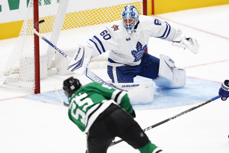 Toronto Maple Leafs goaltender Joseph Woll (60) deflects a shot by Dallas Stars defenseman Thomas Harley (55) during the first period of an NHL hockey game Thursday, Oct. 26, 2023, in Dallas. (AP Photo/Brandon Wade)