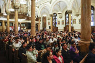 Parishioners attend Easter Mass at Sacred Heart of Jesus and Saint Patrick, Sunday, March 31, 2024, in Baltimore, Md. (AP Photo/Julia Nikhinson)