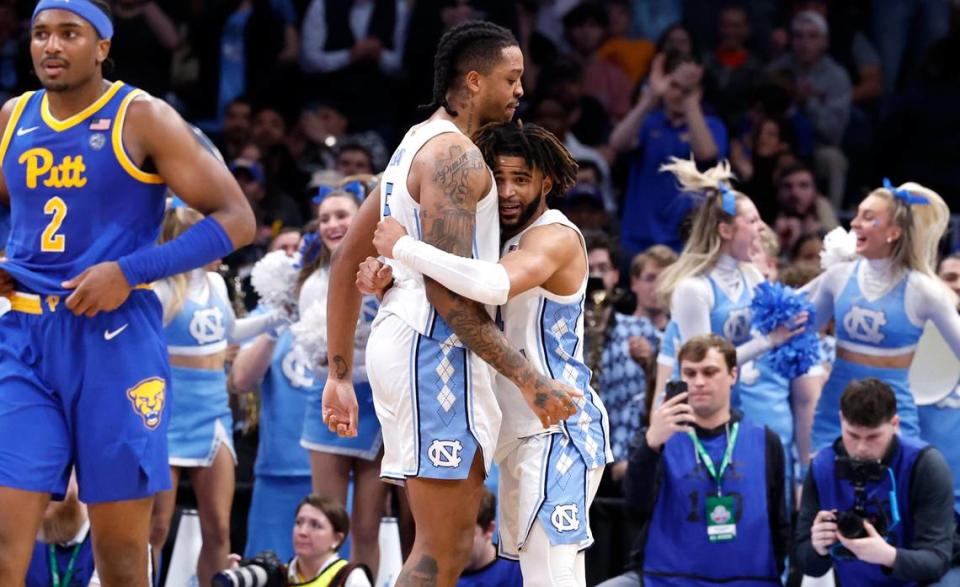 North Carolina’s RJ Davis (right) and Armando Bacot hug earlier this season. The two will lead the Tar Heels into the NCAA Tournament Thursday, after a one-year absence from March Madness. UNC is a No. 1 seed and will face No. 16 seed Wagner at 2:45 p.m. in Charlotte.