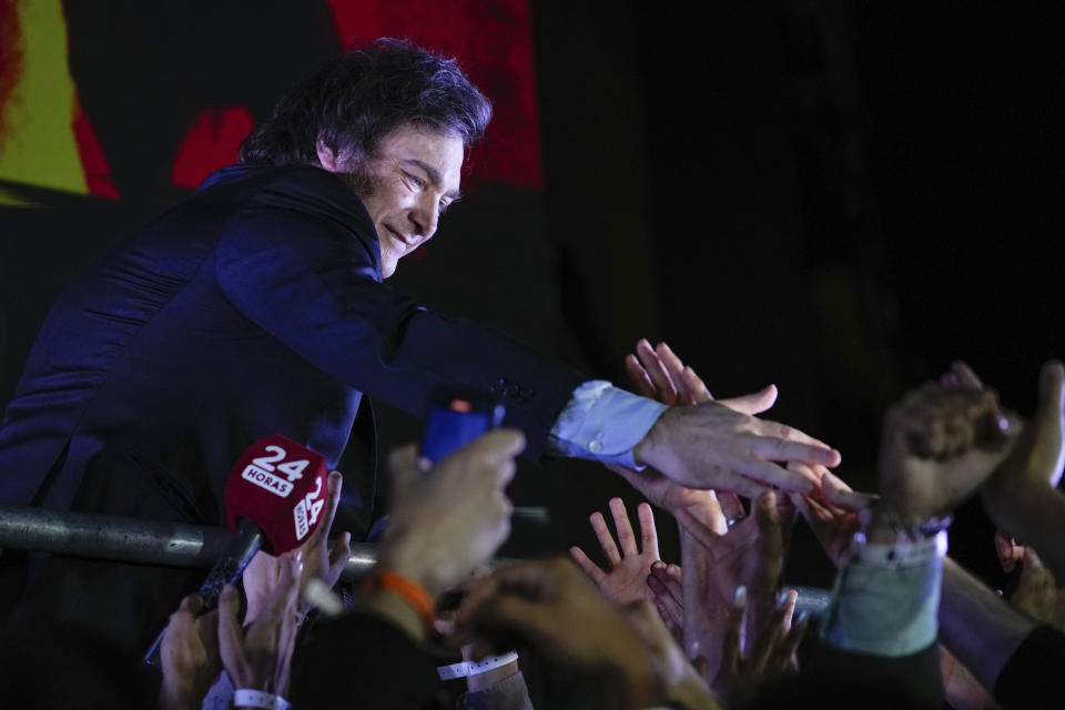 Presidential candidate of the Liberty Advances coalition Javier Milei greets supporters outside his campaign headquarters after winning the presidential runoff election in Buenos Aires, Argentina, Sunday, Nov. 19, 2023. (AP Photo/Natacha Pisarenko)