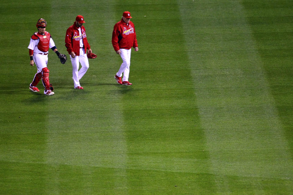 ST LOUIS, MO - OCTOBER 27: (L-R) Catcher Yadier Molina #4, starting pitcher Jaime Garcia #54 and pitching coach Dave Duncan walk on the field prior to Game Six of the MLB World Series against the Texas Rangers at Busch Stadium on October 27, 2011 in St Louis, Missouri. (Photo by Dilip Vishwanat/Getty Images)