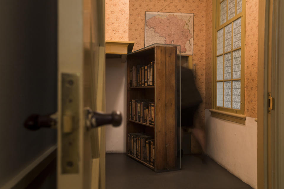 FILE - A woman enters the secret annex at the renovated Anne Frank House Museum in Amsterdam, Netherlands, Wednesday, Nov. 21, 2018. The Anne Frank House museum is releasing on Thursday, Aug. 4, 2022, an English-language version of a series of three videos in which an actress playing the young Jewish diarist tells of the last six months of her life, from her arrest to her death in a Nazi concentration camp. (AP Photo/Peter Dejong, File)