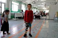 Idris poses for a photograph at the Red Cross rehabilitation center in Kabul