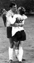 FILE - In this July 26, 1966 file photo England's goalkeeper Gordon Banks, left, hugs midfielder Nobby Stiles after the World Cup semi-final soccer match played at Wembley, London. English soccer club Stoke said Tuesday Feb. 12, 2019 that World Cup-winning England goalkeeper Gordon Banks has died at 81. (AP Photo/Bippa, File)