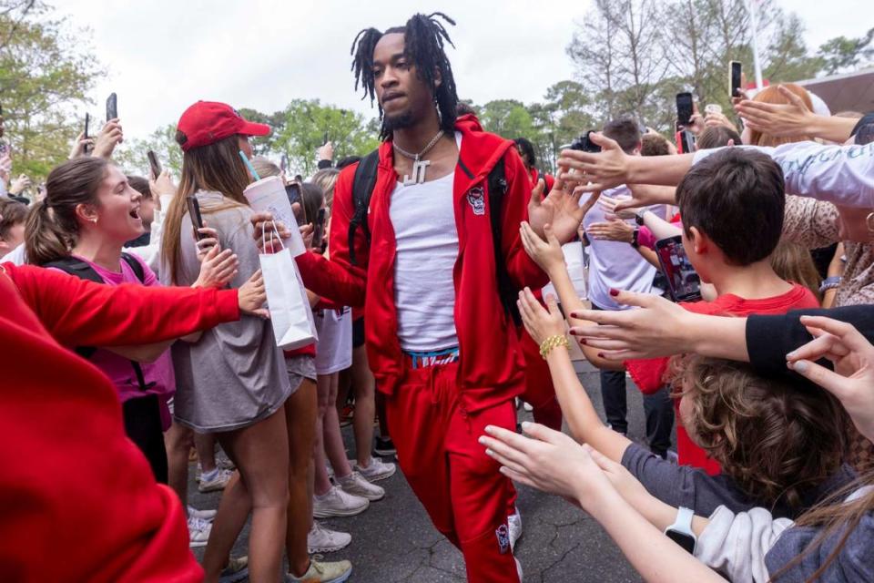 NC.State’s Jayden Taylor is greeted by fans as the men’s basketball team departs on a bus Wednesday, April 3, 2024. NC State’s men’s basketball team is headed to the Final Four for the first time since 1983. Travis Long/tlong@newsobserver.com