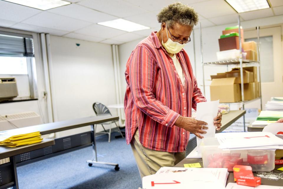 Volunteer Myrna Mitchell-Withers works to get materials ready for the precincts for election day at the Lansing City Clerk's Election Unit on Monday, Aug. 3, 2020, in Lansing.