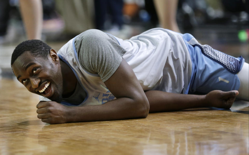 North Carolina forward Theo Pinson laughs as he stretches during a practice session for their NCAA Final Four tournament college basketball semifinal game Friday, March 31, 2017, in Glendale, Ariz. (AP Photo/David J. Phillip)