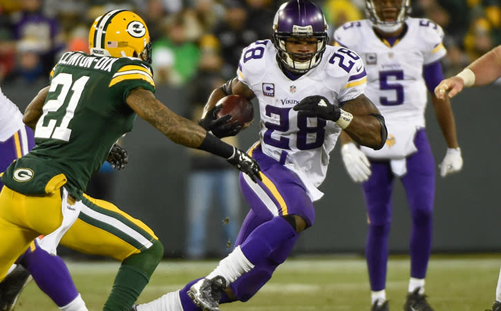 Jan 3, 2016; Minnesota Vikings running back Adrian Peterson tries to run past Green Bay Packers safety Ha Ha Clinton-Dix in the third quarter at Lambeau Field.