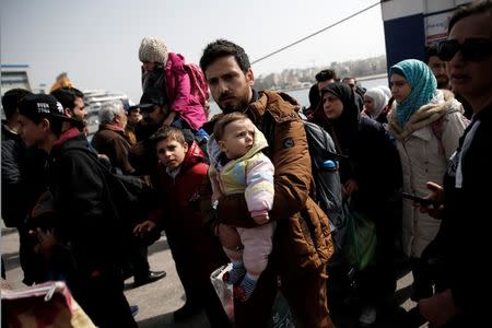 Refugees and migrants arrive aboard the Diagoras passenger ship at the port of Piraeus, near Athens, Greece, March 1, 2016. REUTERS/Alkis Konstantinidis