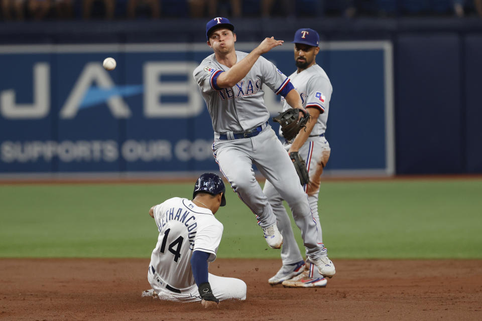 Texas Rangers shortstop Corey Seager throws to first after forcing out Tampa Bay Rays' Christian Bethancourt during the second inning of a baseball game Friday, Sept. 16, 2022, in St. Petersburg, Fla. Taylor Walls was safe at first. (AP Photo/Scott Audette)