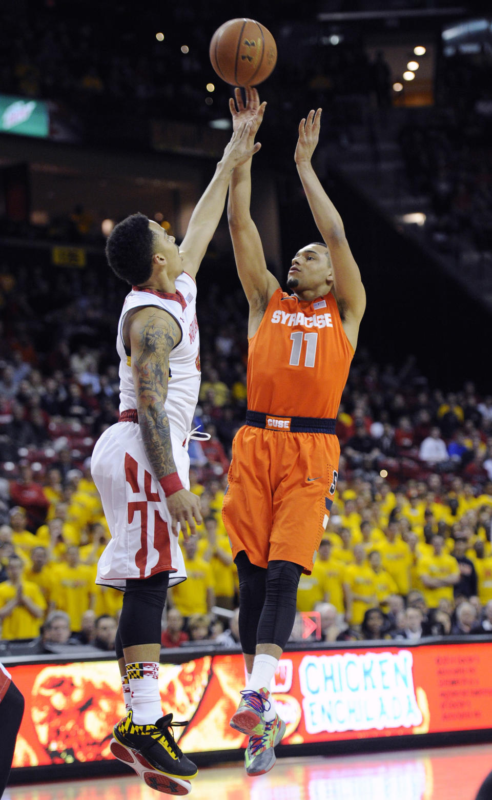 Syracuse guard Tyler Ennis (11) shoots against Maryland guard Seth Allen, left, during the first half of an NCAA college basketball game, Monday, Feb. 24, 2014, in College Park, Md. (AP Photo/Nick Wass)