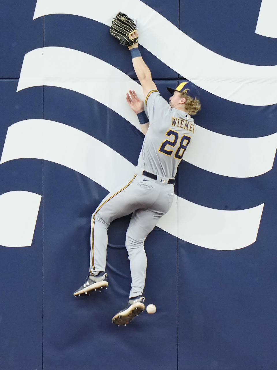 Milwaukee Brewers center fielder Joey Wiemer leaps for but can't make the catch on a double by Toronto Blue Jays' Cavan Biggio during the third inning of a baseball game Wednesday, May 31, 2023, in Toronto. (Frank Gunn/The Canadian Press via AP)