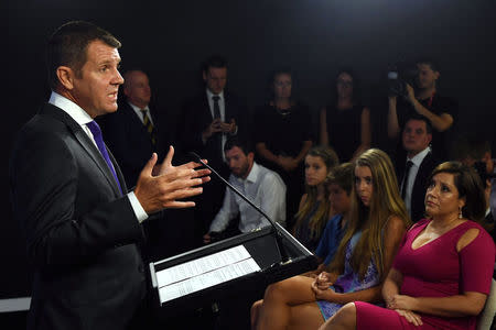 State Premier Mike Baird, the leader of Australia's biggest state economy, New South Wales (NSW), announces his resignation from politics as his wife Kerryn and children Cate, Luke and Laura (front) listen on during a media conference in Sydney, Australia, January 19, 2017. AAP/Paul Miller/via REUTERS