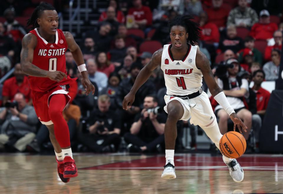 Louisville’s Ty-Laur Johnson brings the ball p the court against NC State’s DJ Home Saturday afternoon in the KFC Yum Center.
Jan. 13, 2024