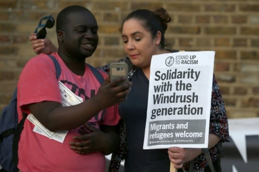 Supporters carry placards at a Windrush generation solidarity protest in Brixton, London