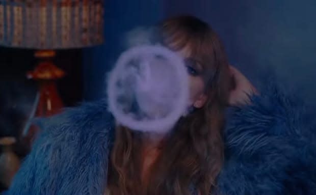 Taylor Swift blowing smoke rings in "Lavender Haze" video<p>YouTube</p>