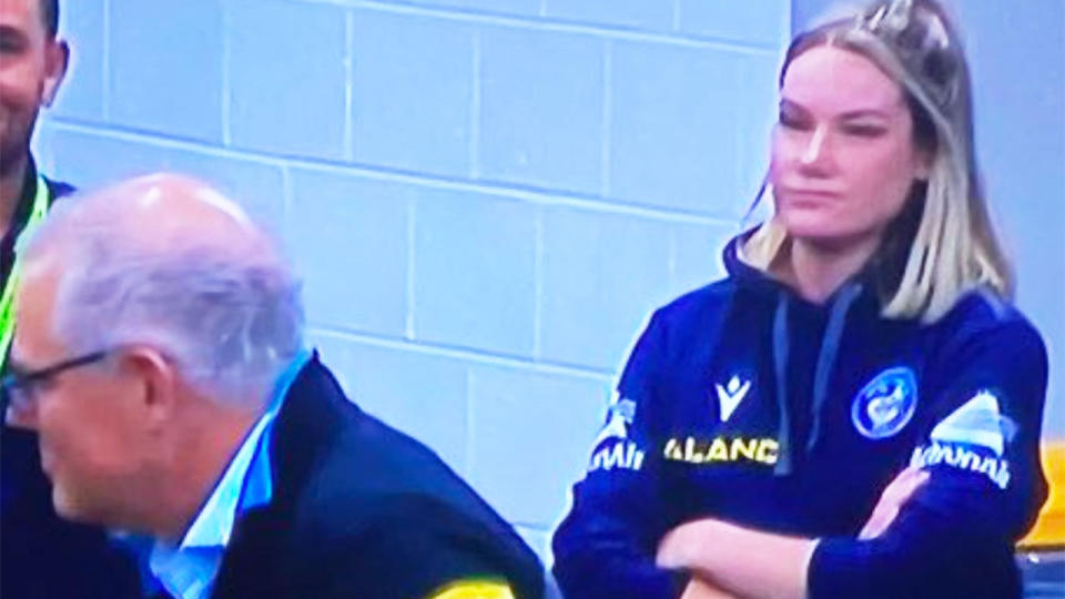 Parramatta Eels' sport scientist Tahleya Eggers (pictured right) crosses her arms as Prime Minister Scott Morrison (pictured left) speaks to the players.