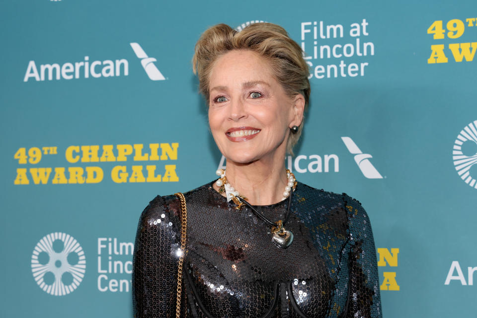 Sharon Stone at the 49th Chaplin Award Gala wearing a sequined outfit with a necklace, smiling for the camera