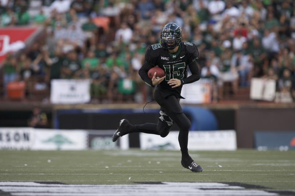 University of Hawaii quarterback Colt Brennan (15) runs the ball during an NCAA football game against the Boise State Broncos at Aloha Stadium. Hawaii defeated Boise State 39-27 to win the 2007 WAC championship. (Photo by Jordan Murph /Icon SMI/Icon Sport Media via Getty Images)