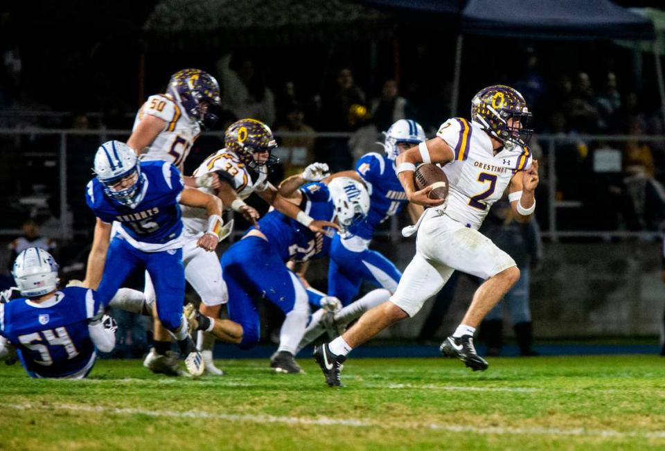 Orestimba’s Juan Esquivez (2) breaks through the defensive line in the Sac-Joaquin Section Division VII-A Championship against Ripon Christian at Ripon Christian High School on Friday, Nov. 17, 2023.