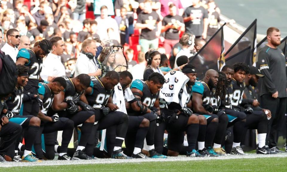 Jacksonville Jaguars vs Baltimore Ravens: players kneel during the U.S. national anthem.