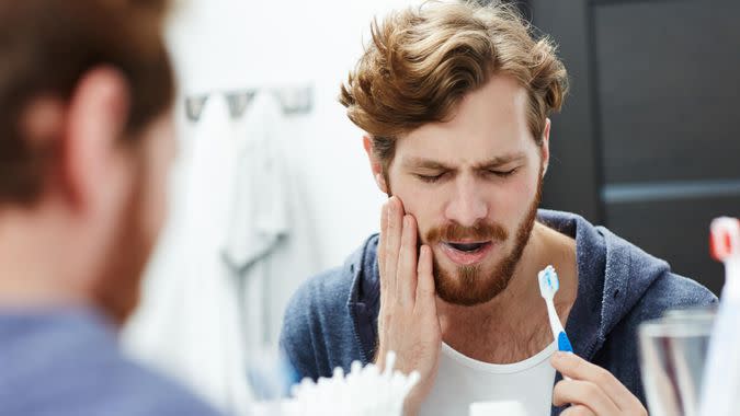 young guy with hurt tooth