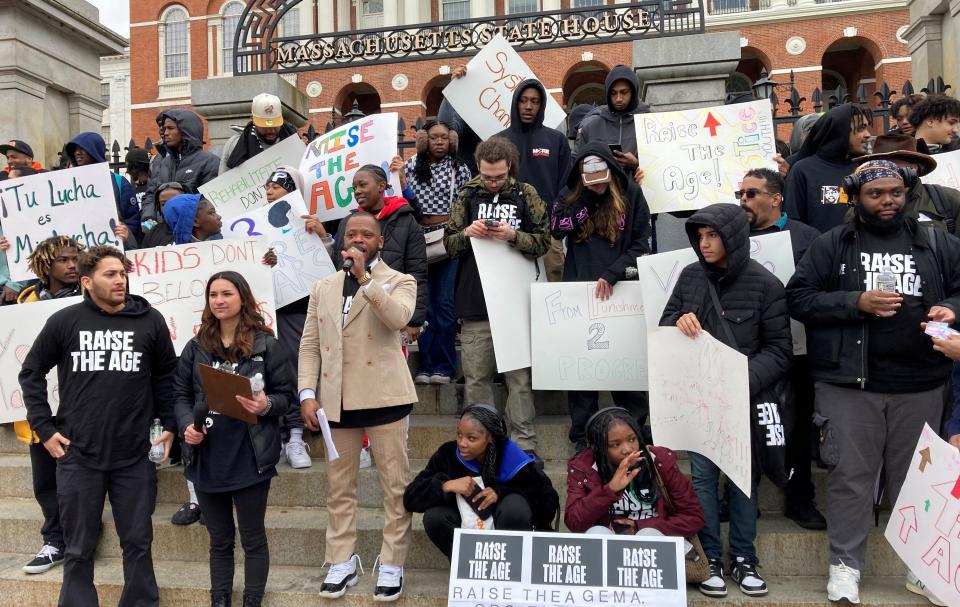 James Mackey, center, of More Than Words addresses the crowd at a rally on the State House steps Thursday.