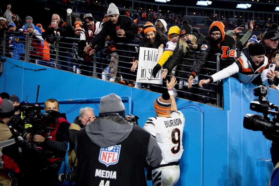 Cincinnati Bengals quarterback Joe Burrow (9) high fives fans after an NFL divisional playoff football game, Saturday, Jan. 22, 2022, at Nissan Stadium in Nashville, Tenn. Cincinnati Bengals defeated Tennessee Titans 19-16.