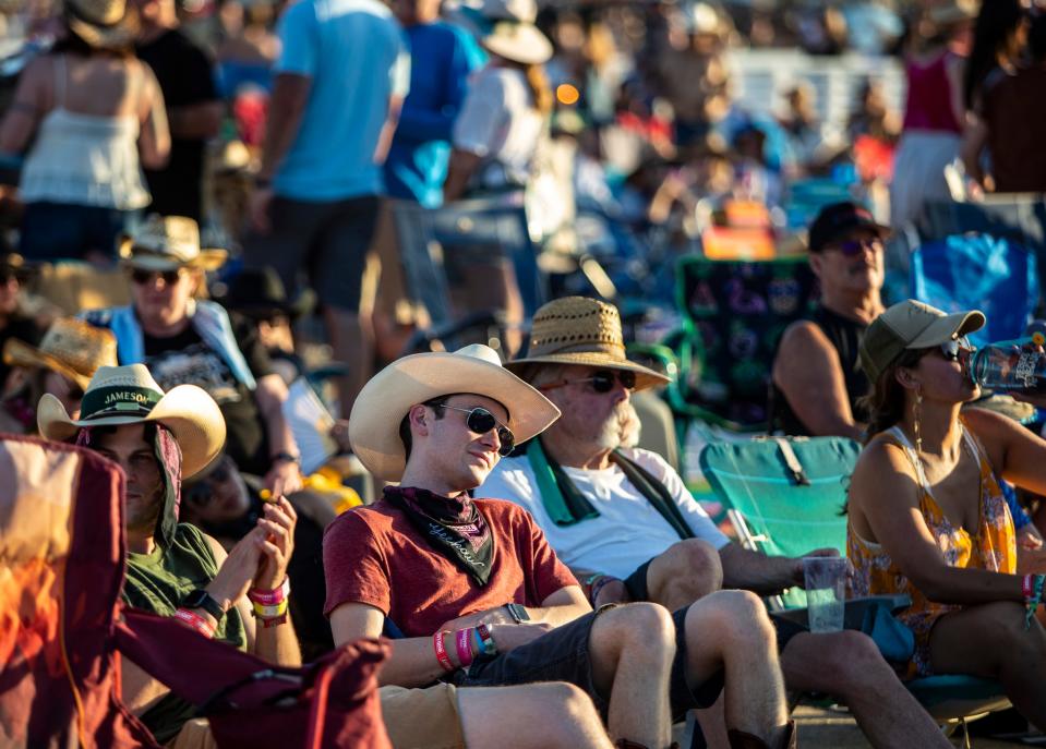 Festivalgoers sit in an area allowing camp chairs to listen to Elle King as she performs on the Mane stage at Stagecoach at the Empire Polo Club in Indio, Calif., Friday, April 28, 2023. 