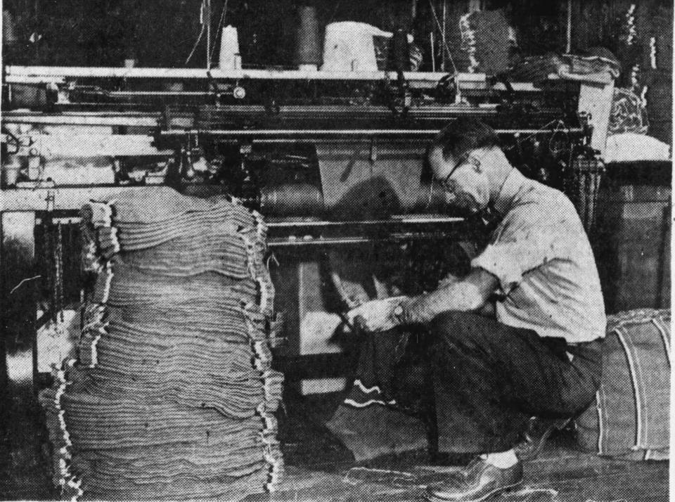 E.W. Hardler, vice president of the Binghamton Knitting Company, checks another type of knitting machine in 1950.
