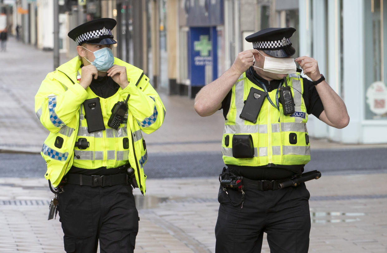 Police patrol alongside the queue outside the Primark store on Princes Street in Edinburgh, which reopens today as part of Scotland's phased plan to ease out of the coronavirus pandemic lockdown.