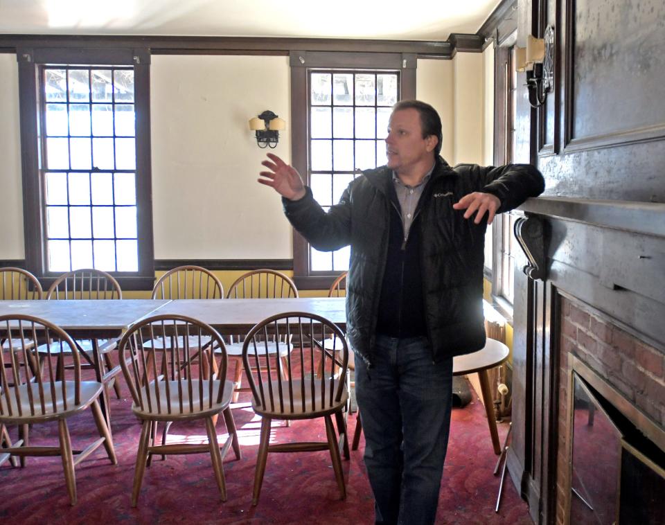 Auctioneer Paul Zekos stands in one of the private dining areas of the historic 113-year-old Sterling Inn Restaurant and Hotel, which will be auctioned off on Friday.