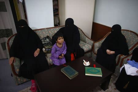 Uighur refugees wait during an interview with Reuters in Istanbul,Turkey, July 16, 2015. REUTERS/Osman Orsal