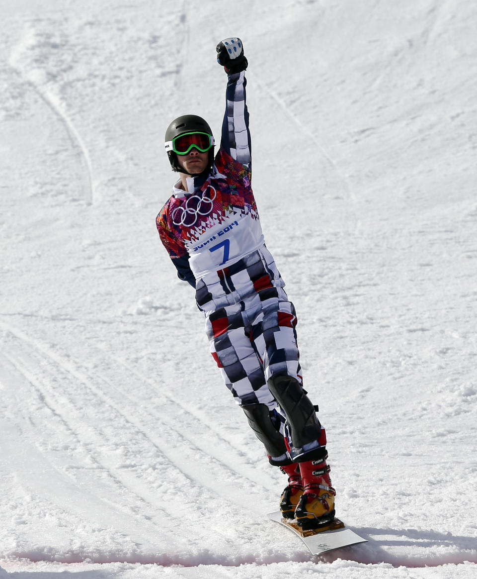 Russia's Vic Wild celebrates as he crosses the line to win the gold medal in the men's snowboard parallel giant slalom final at the Rosa Khutor Extreme Park, at the 2014 Winter Olympics, Wednesday, Feb. 19, 2014, in Krasnaya Polyana, Russia. (AP Photo/Andy Wong)