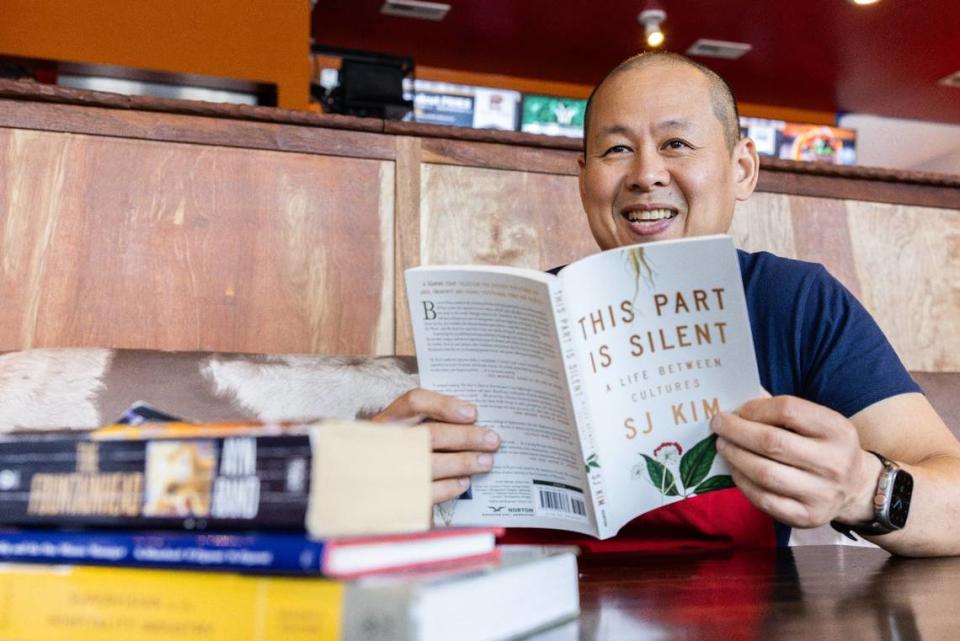 Joe Huang, owner of Bang Bang Burgers in Charlotte, shows off some of the books he plans to read over the summer.