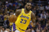 FILE - In this Saturday, March 2, 2019, file photo, Los Angeles Lakers forward LeBron James (23) controls the ball in the second half during an NBA basketball game against the Phoenix Suns in Phoenix. That LeBron James jersey could get a little more expensive. Companies that make clothing and shoes for the National Basketball Association players are in the crosshairs of President Donald Trump’s escalating China trade wars. (AP Photo/Rick Scuteri, File)