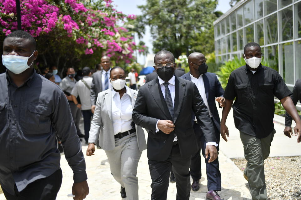 Interim Prime Minister Claude Joseph leaves a memorial service for late Haitian President Jovenel Moise at the National Pantheon Museum in Port-au-Prince, Haiti, Tuesday, July 20, 2021. Designated Prime Minister Ariel Henry is expected to be sworn in later in the day to replace Joseph, who assumed leadership of Haiti with the backing of police and the military after the July 7 attack at Moïse's private home. (AP Photo/Matias Delacroix)