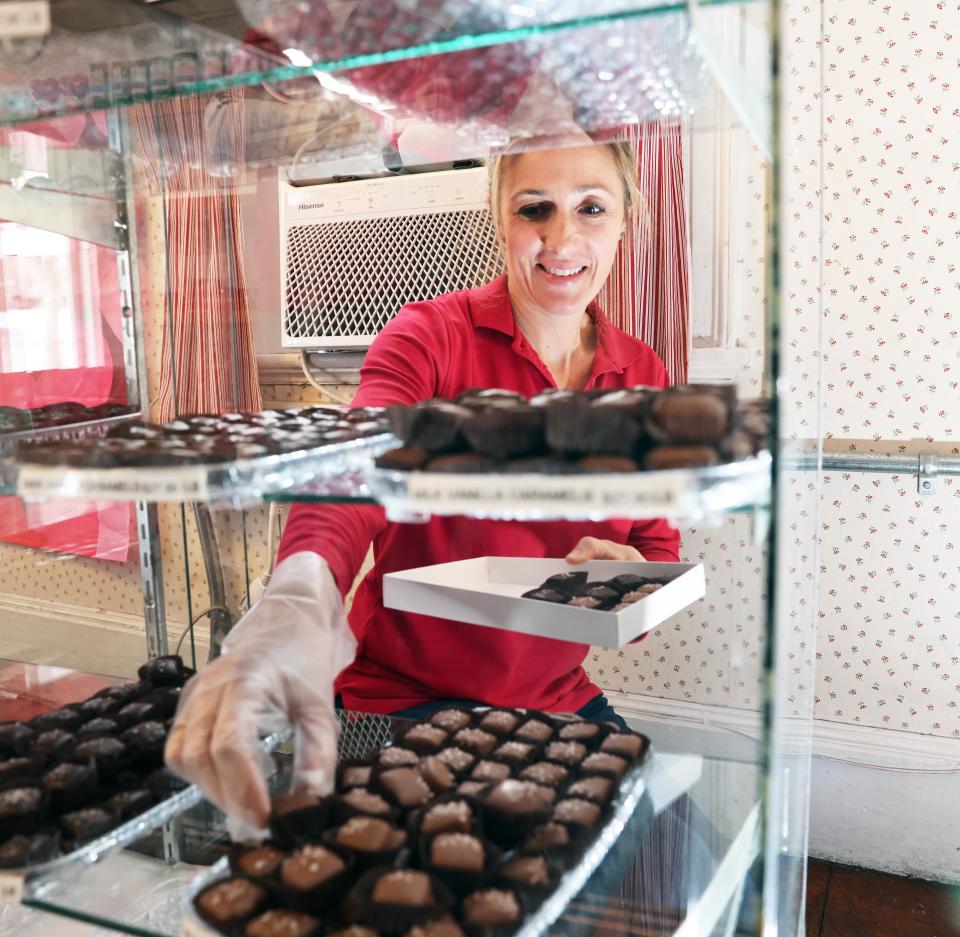 Sarah Daley-Prario places truffles in a box for a customer at Skinners Sugar House in East Bridgewater on Thursday, Jan. 18, 2024.