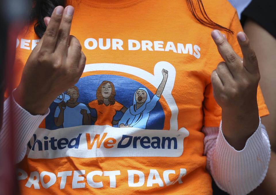 United We Dream youths and allies snap their fingers to show support to other DACA recipients speaking to the media after a court hearing in lawsuit filed by states challenging DACA program at the United States District Courthouse on Wednesday, Aug. 8, 2018, in Houston. (Yi-Chin Lee/Houston Chronicle via AP)