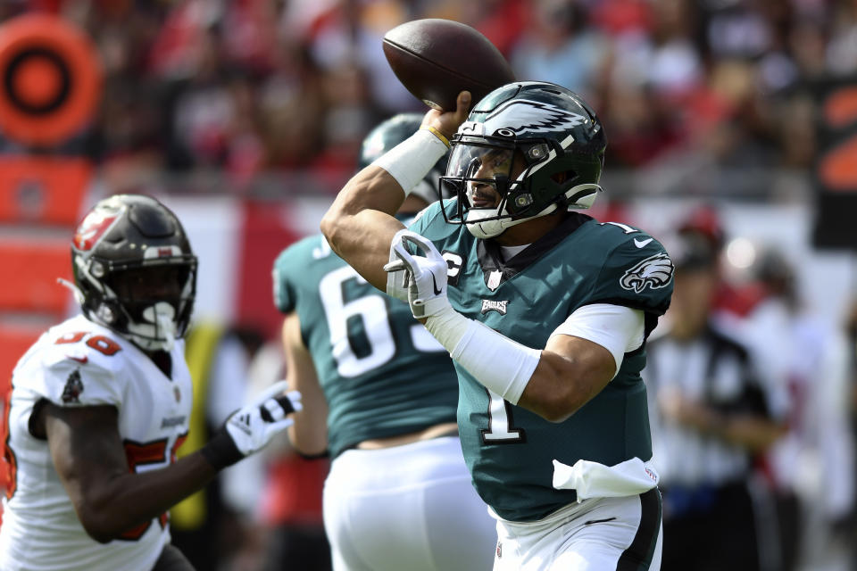 Philadelphia Eagles quarterback Jalen Hurts (1) throws a pass against the Tampa Bay Buccaneers during the first half of an NFL wild-card football game Sunday, Jan. 16, 2022, in Tampa, Fla. (AP Photo/Jason Behnken)