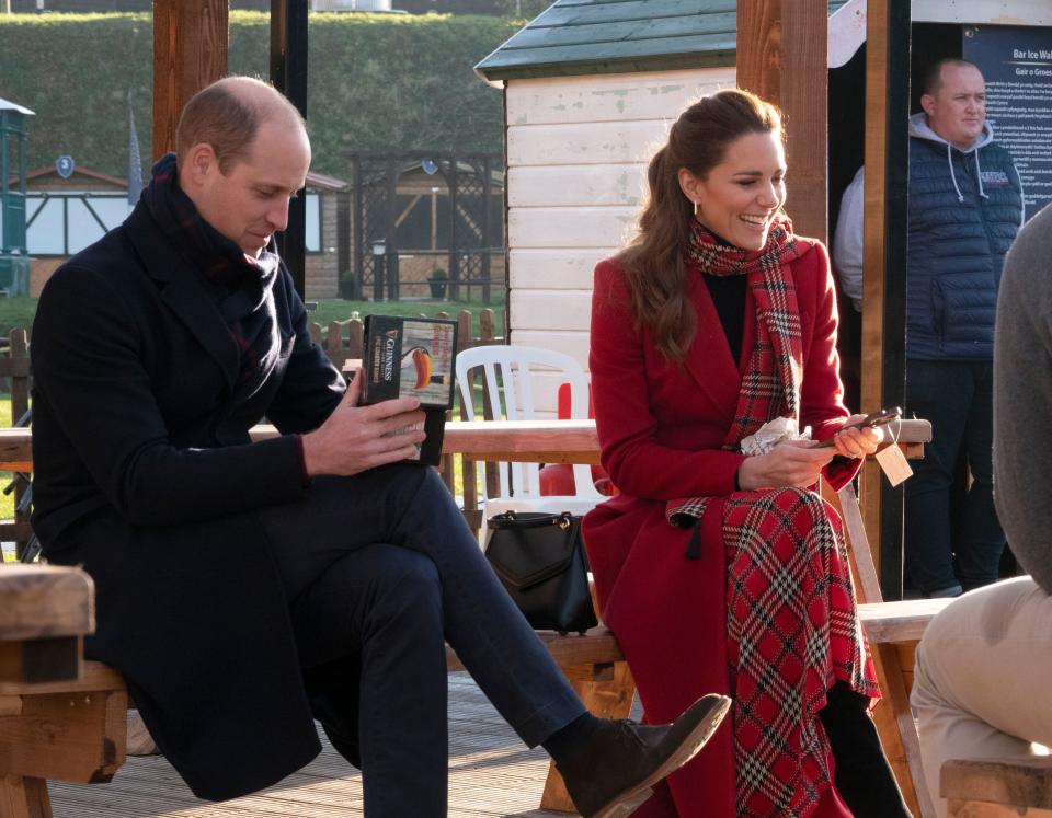 Britain's Prince William, Duke of Cambridge and Britain's Catherine, Duchess of Cambridge receive gifts during a visit to Cardiff Castle in Cardiff in south Wales, on December 8, 2020, on the final day of engagements on their tour of the UK. - During their trip, their Royal Highnesses hope to pay tribute to individuals, organisations and initiatives across the country that have gone above and beyond to support their local communities this year. (Photo by Jonathan Buckmaster / POOL / AFP) (Photo by JONATHAN BUCKMASTER/POOL/AFP via Getty Images)