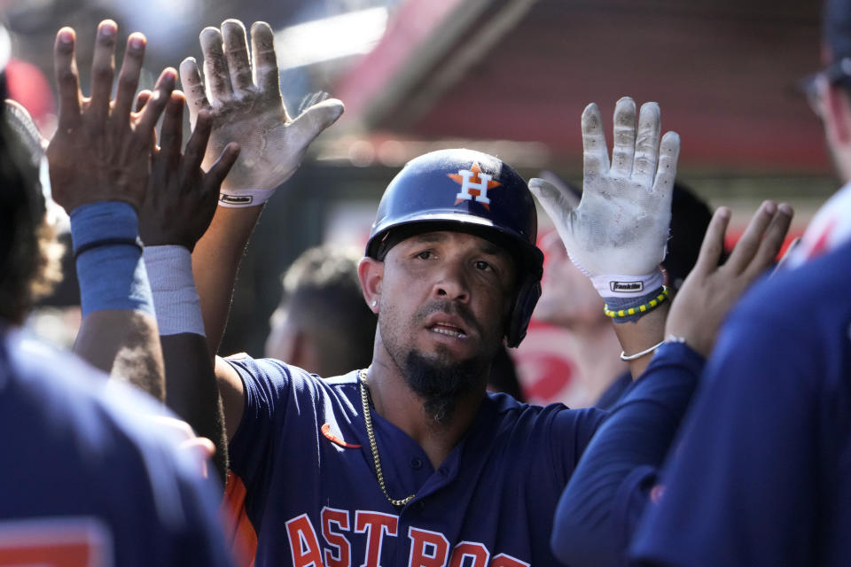 Houston Astros' Jose Abreu is congratulated by teammates after hitting a solo home run during the third inning of a spring training baseball game against the St. Louis Cardinals Thursday, March 2, 2023, in Jupiter, Fla. (AP Photo/Jeff Roberson)