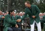 Jordan Spieth (R) of the U.S. shakes the hand of 2014 Masters champion Bubba Watson after winning the 2015 Masters golf tournament at the Augusta National Golf Course in Augusta, Georgia April 12, 2015. REUTERS/Phil Noble