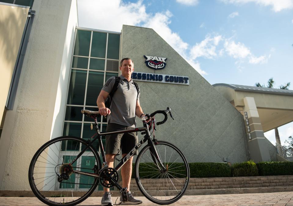 Florida Atlantic men's basketball coach Dusty May poses for a portrait with his bicycle, a Felt road bike, in front of the Eleanor R. Baldwin Arena on Thursday, April 27, 2023 in Boca Raton, Fla.